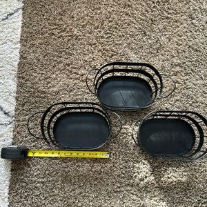 Three black metal bins